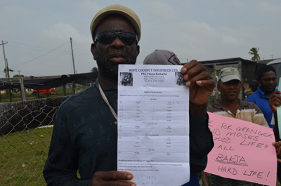 A farmer displays the sheet with the new rental rates